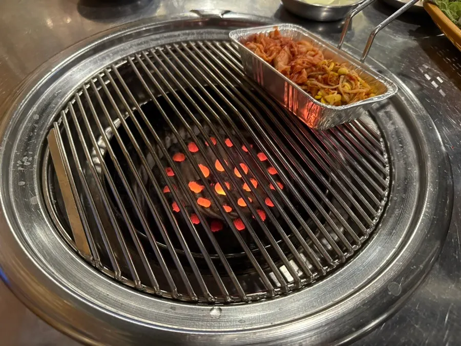 Charcoal and grill plate brought to the table