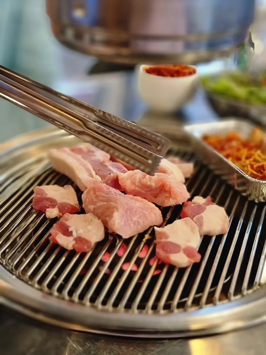 Pork platter meat placed on the charcoal grill