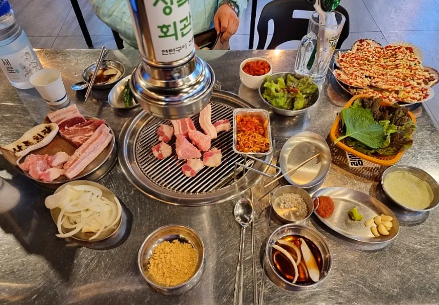 Thick cuts of meat cooking evenly over charcoal
