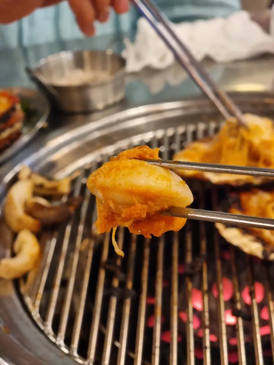 Cheese pulling from the cheese scallop grill