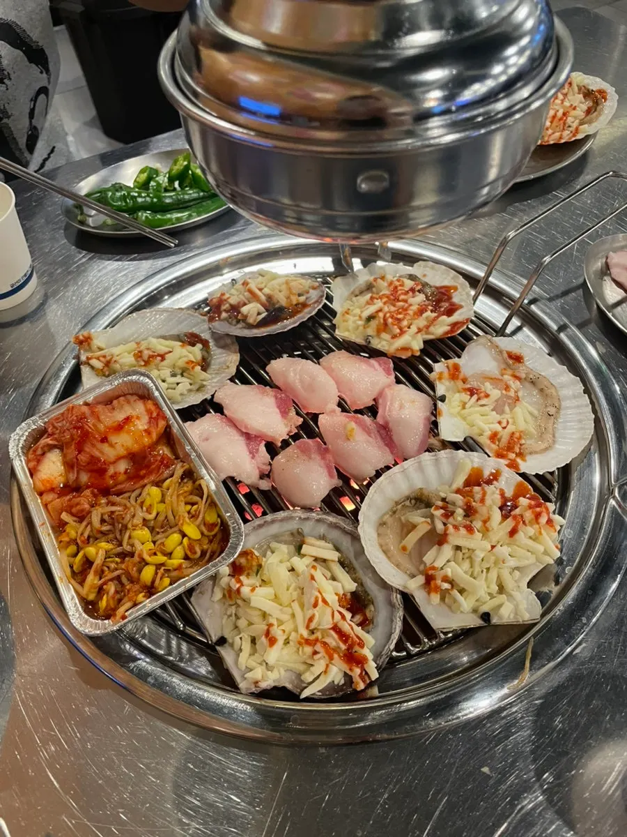 Seafood cooking on the charcoal grill plate