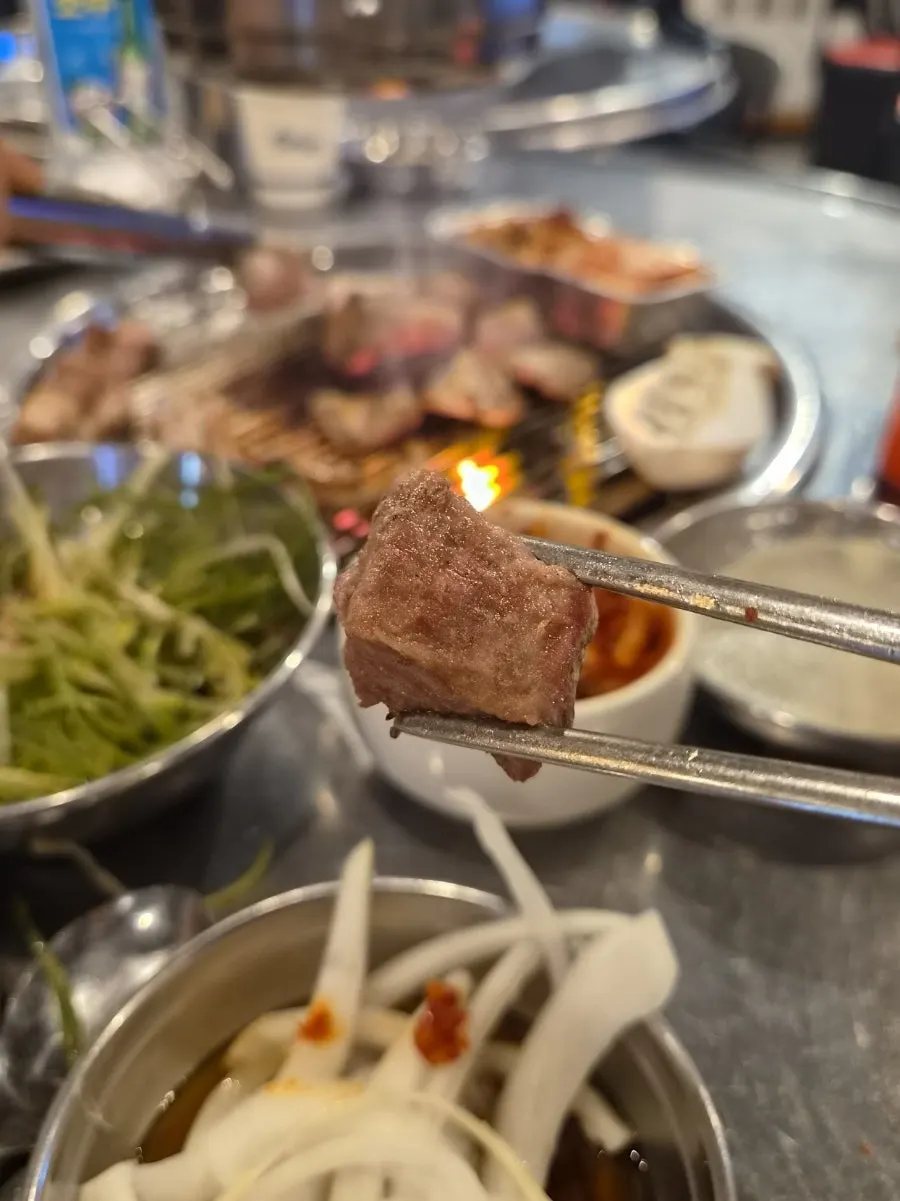 Pork belly being rolled and grilled for smoky flavor