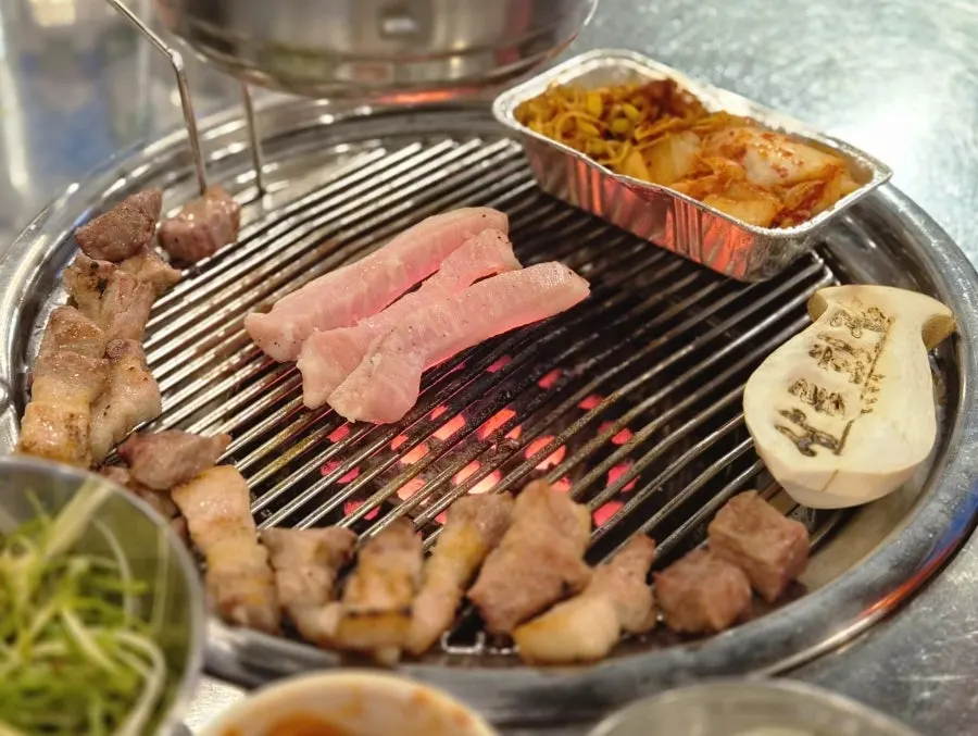 Fully cooked pork belly and moksal on the grill