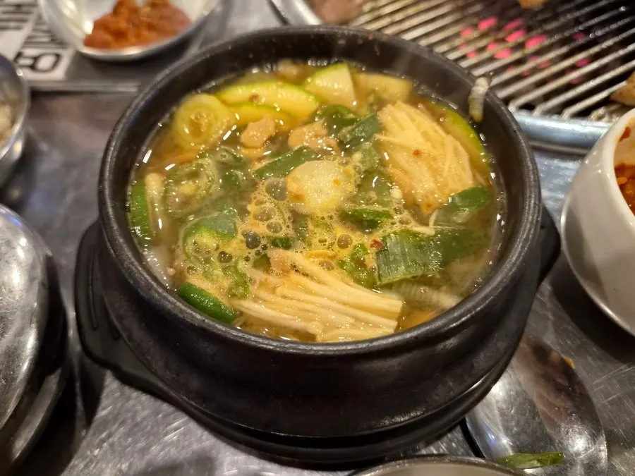 Stone pot doenjang jjigae with mushrooms and zucchini