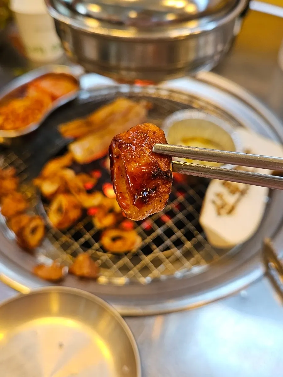 Photo of the meat table with a raised glass