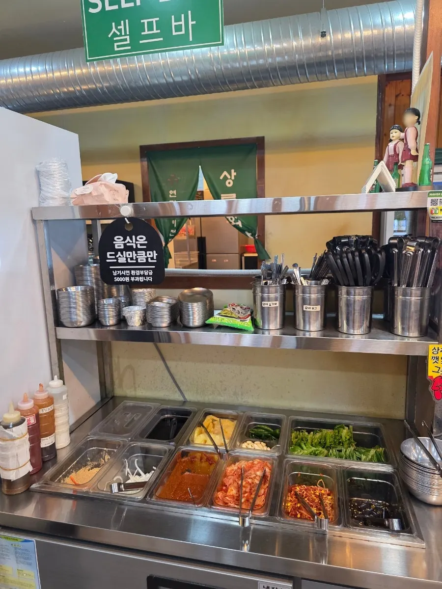 Self-serve bar with side dishes and vegetables in the middle of the restaurant