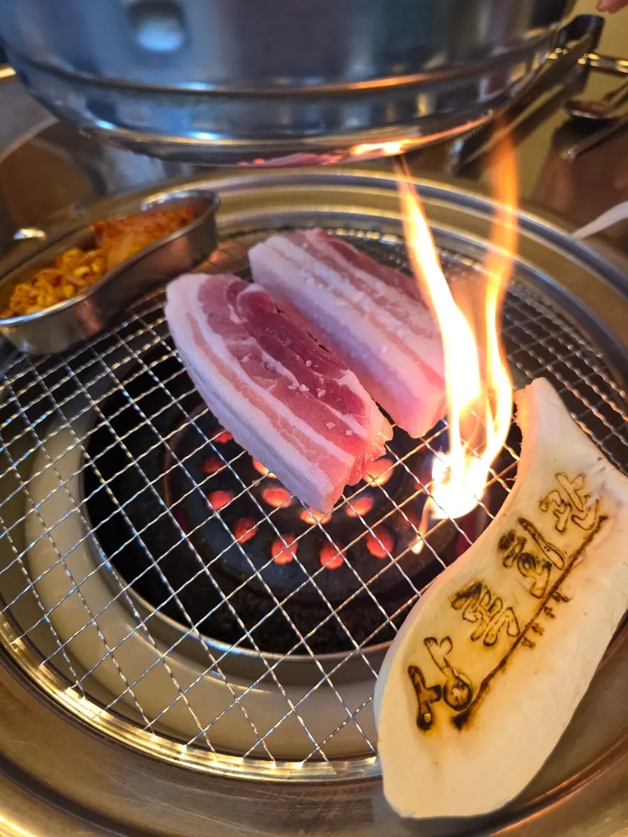Samgyeopsal grilling over the charcoal fire