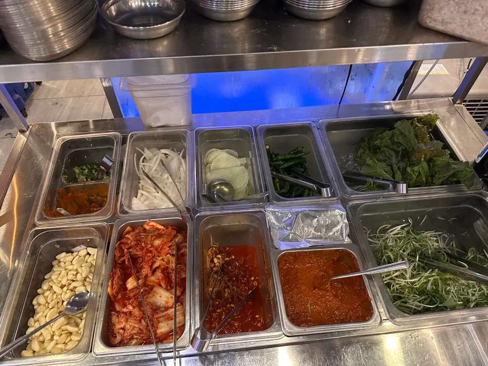 Self bar corner with kimchi, garlic, and other side dishes