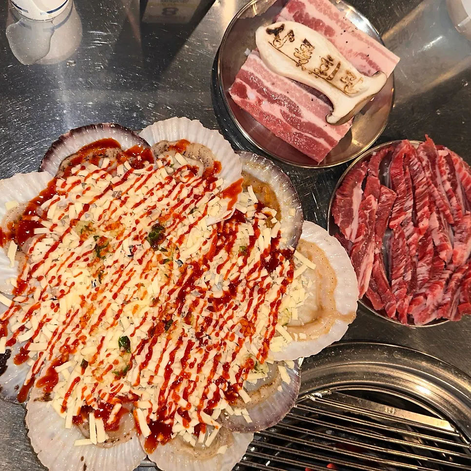 Table spread with pork belly, beef skirt meat, and cheese scallops