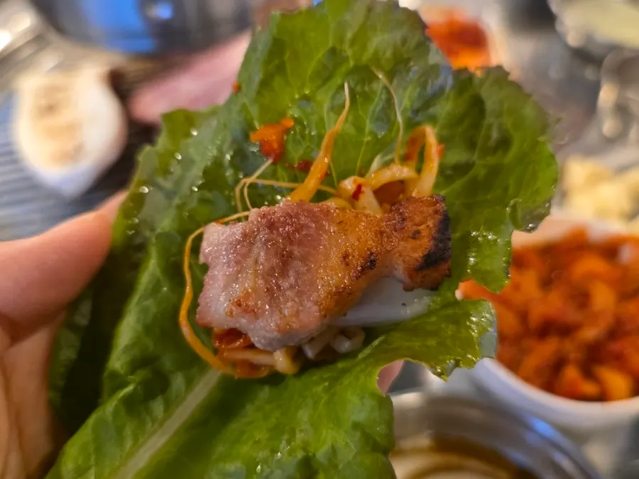 Grilled meat served with self-serve side dishes