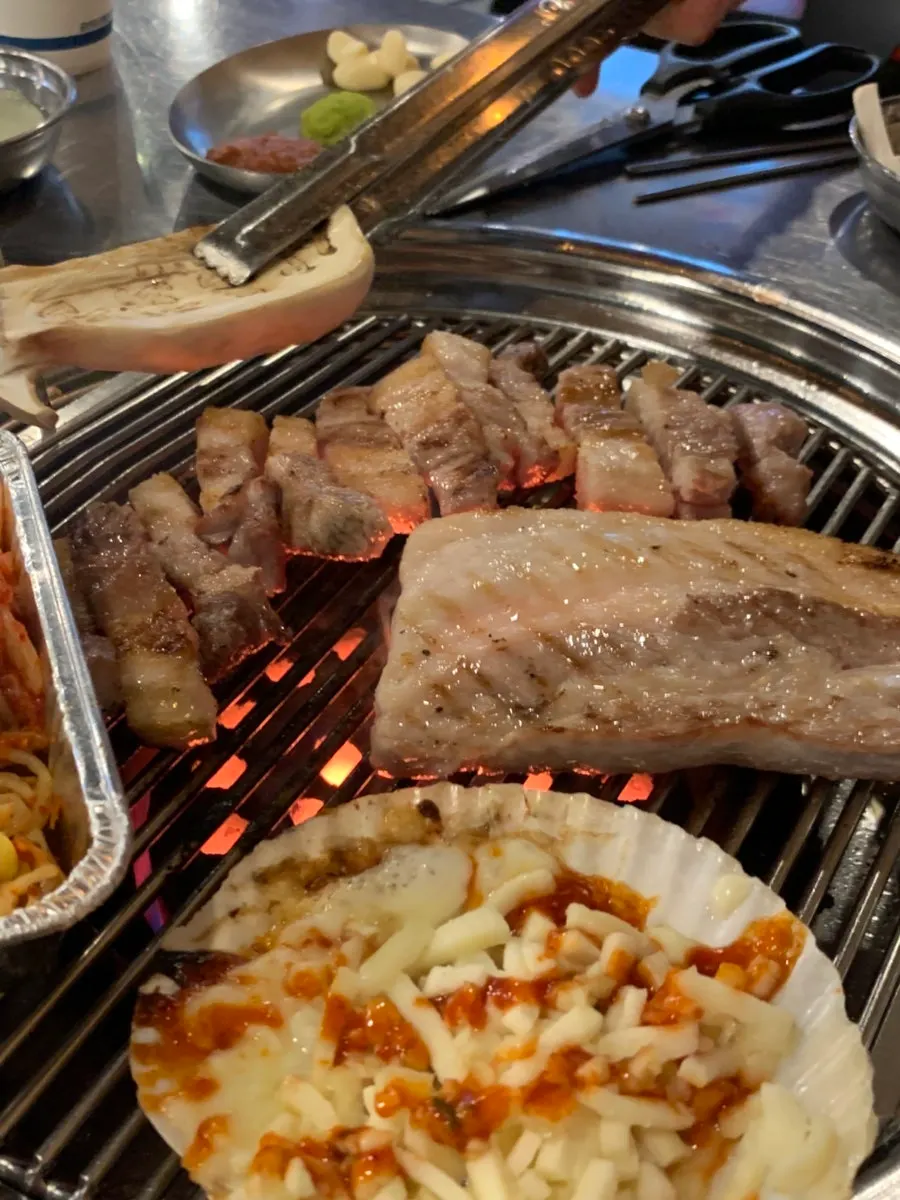 Thick pork belly grilling on the charcoal brazier