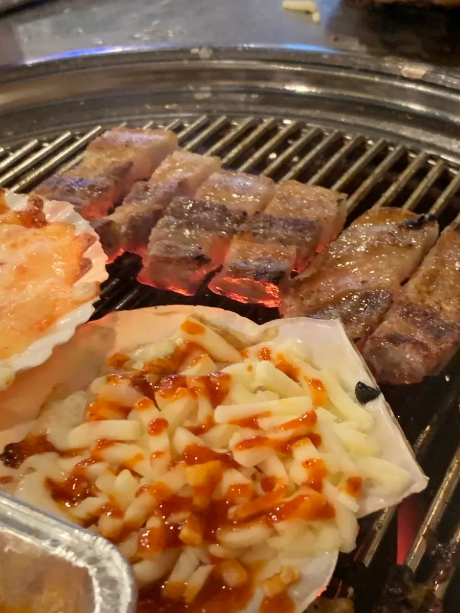 Cheese scallops bubbling on the grill