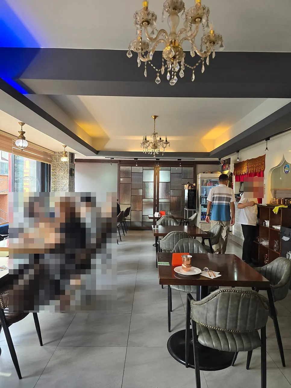 Window seats with diners eating curry