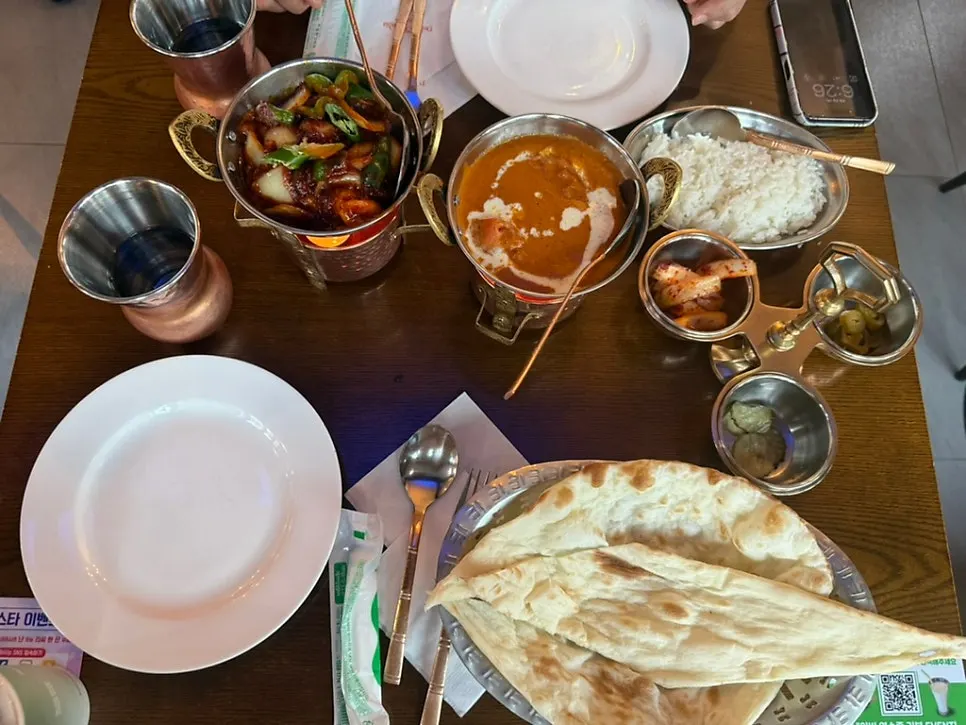 Indian curry meal with several dishes on the table