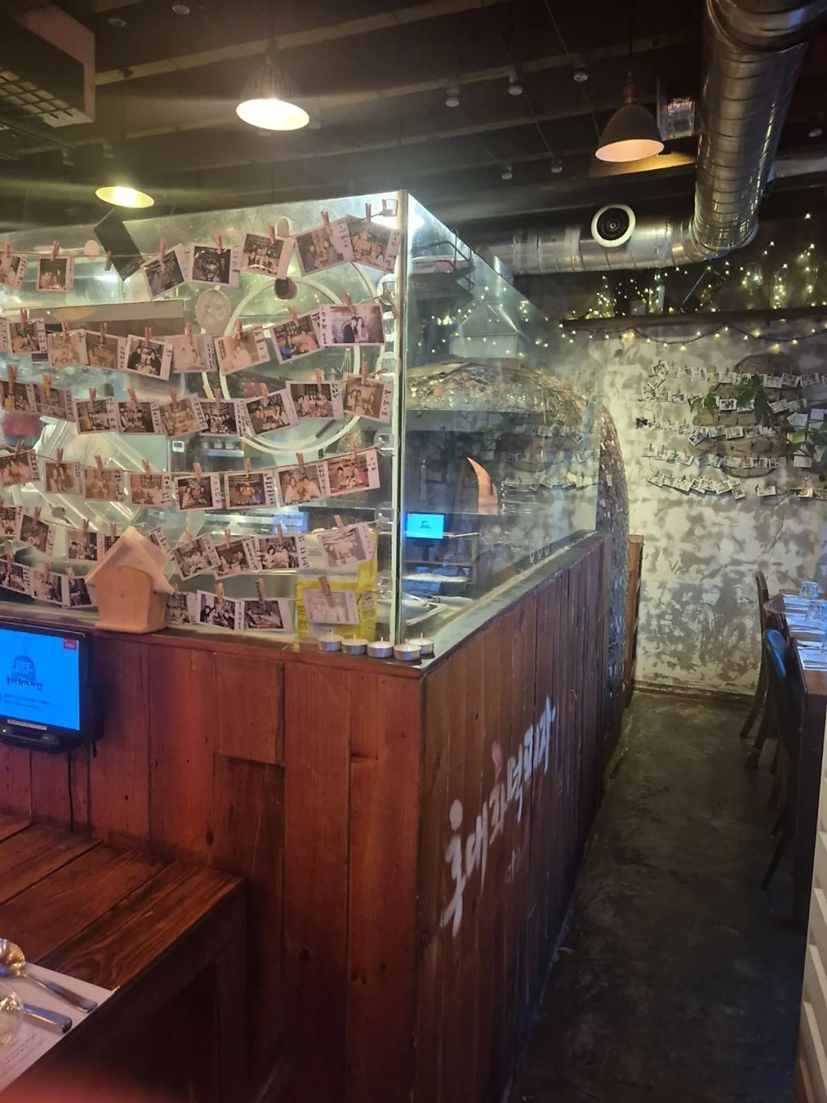 Interior of Hongdae Hwadeok Pizza under warm lighting