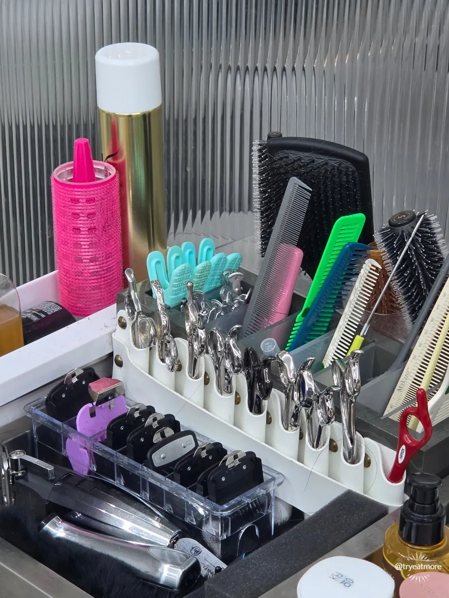 Bleach powder alongside neatly arranged scissors and combs