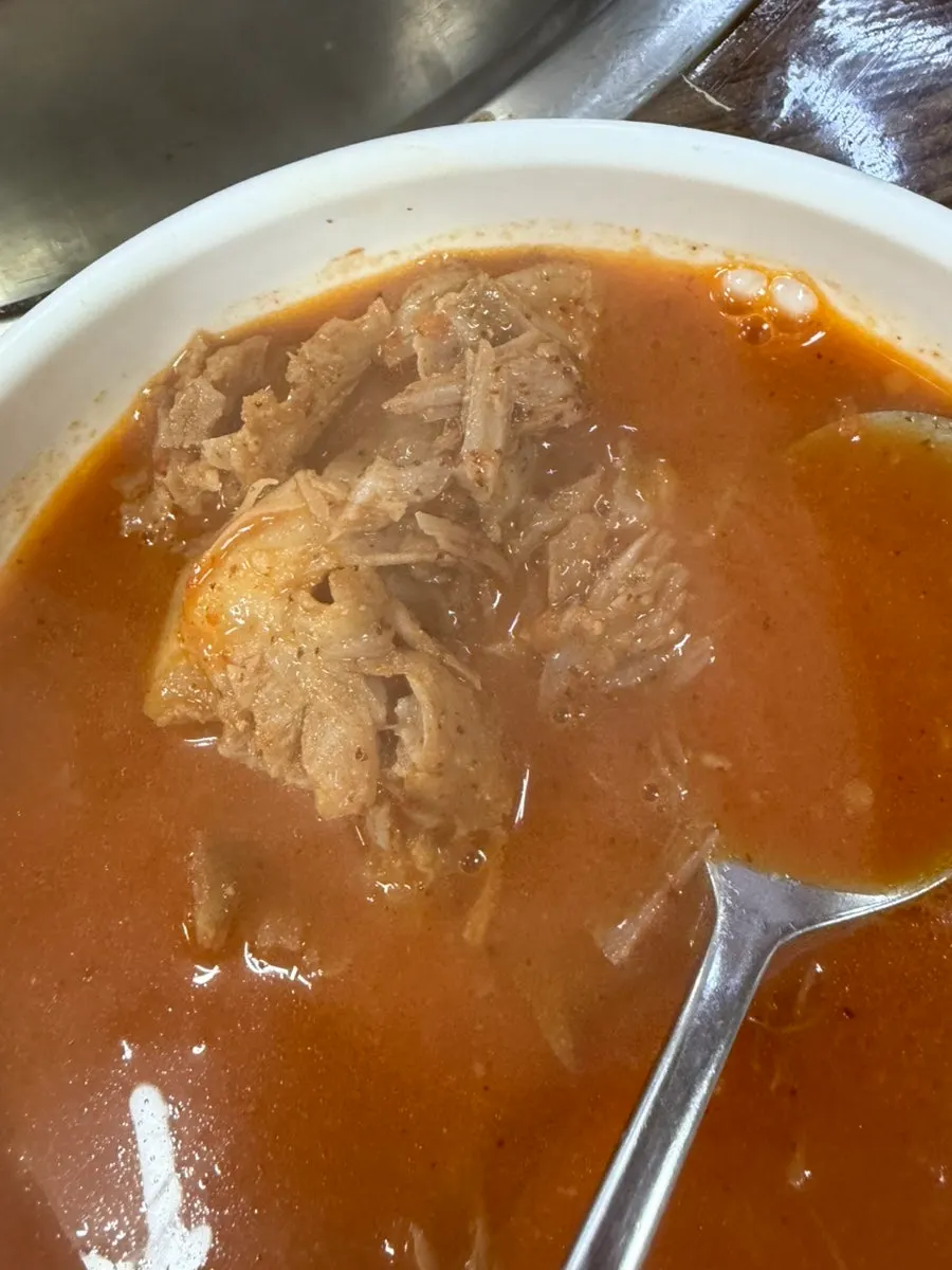 A bowl of gamjatang with meat picked off the bones