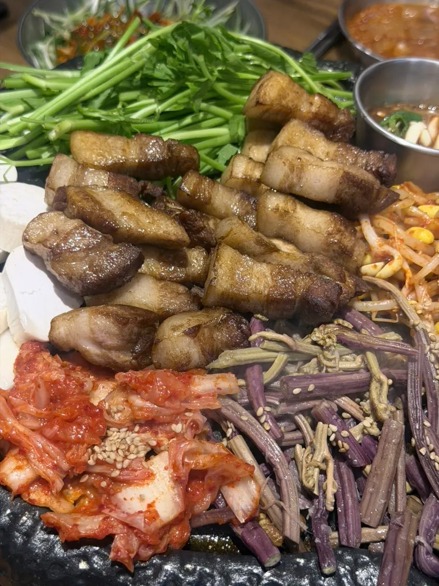 Kimchi and bean sprouts cooking in pork fat