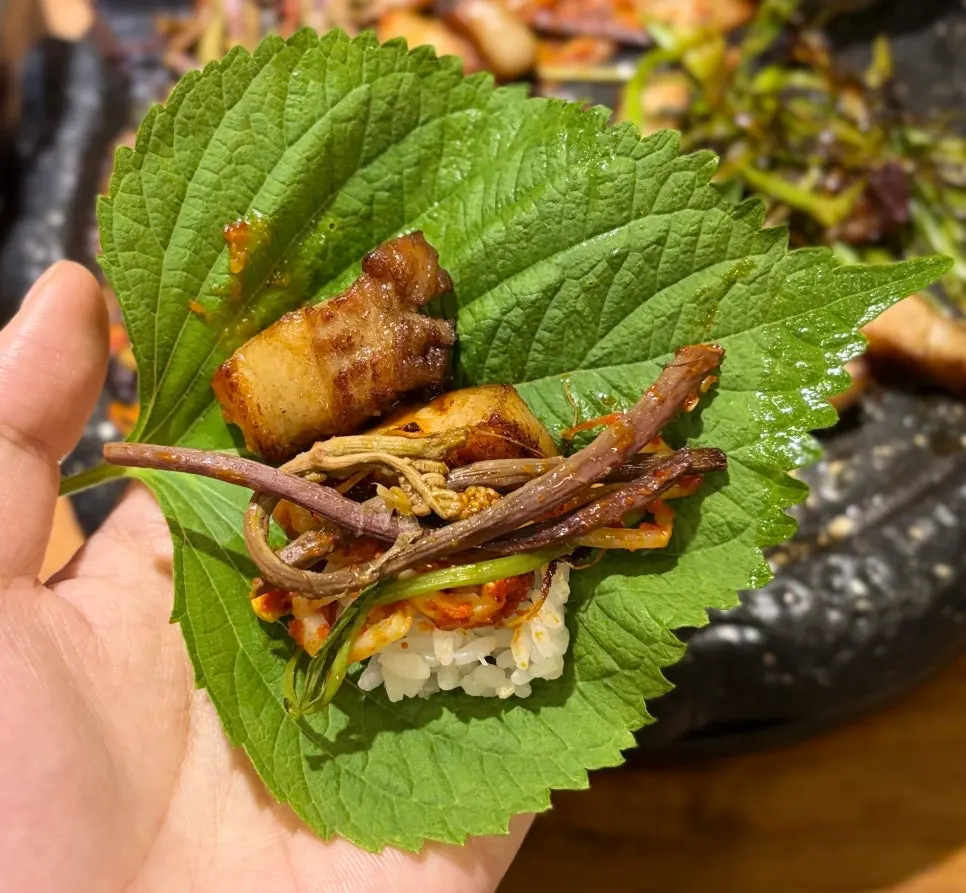 Perilla leaf wrap topped with rice and pork belly