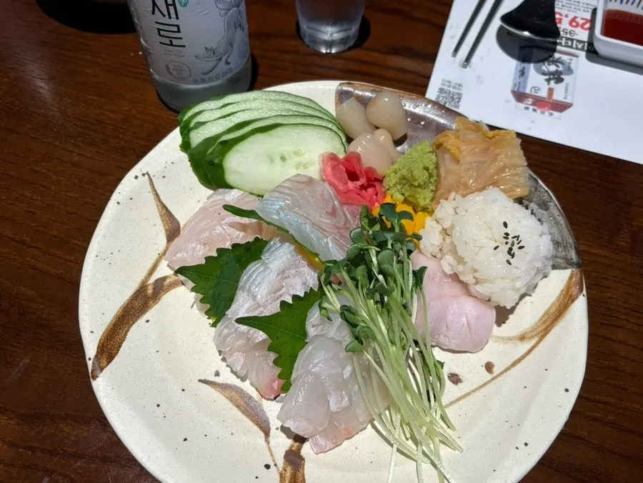 Halibut sashimi plated with vegetables