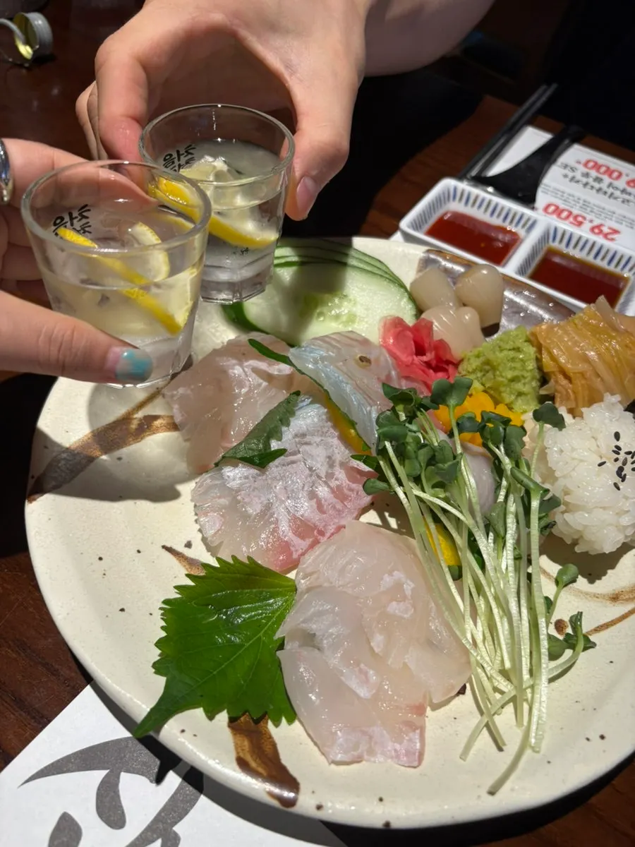 A piece of halibut sashimi with vegetables