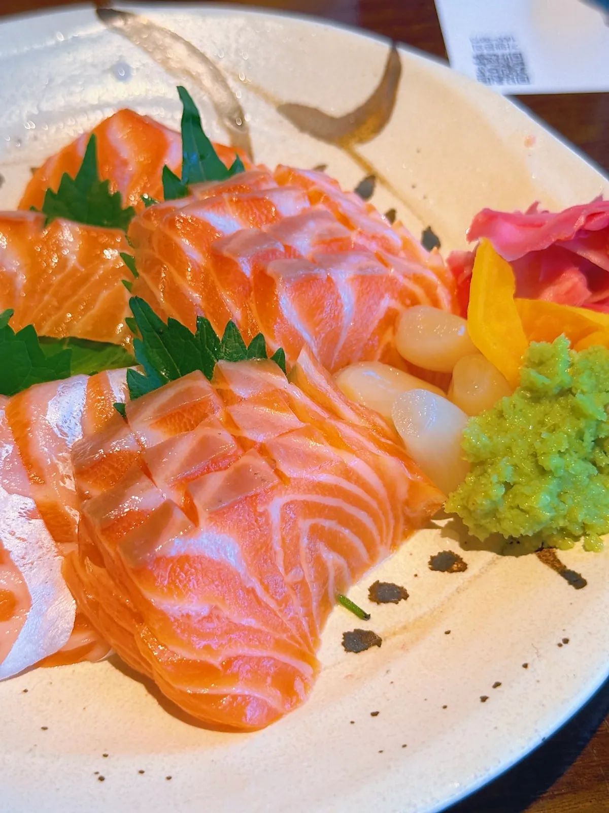 A plate of thickly sliced salmon sashimi