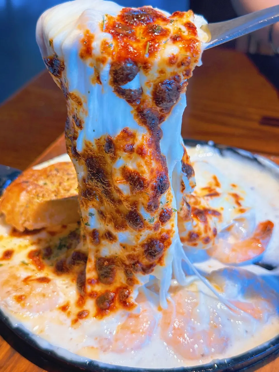 Shrimp fondue topped with cheese