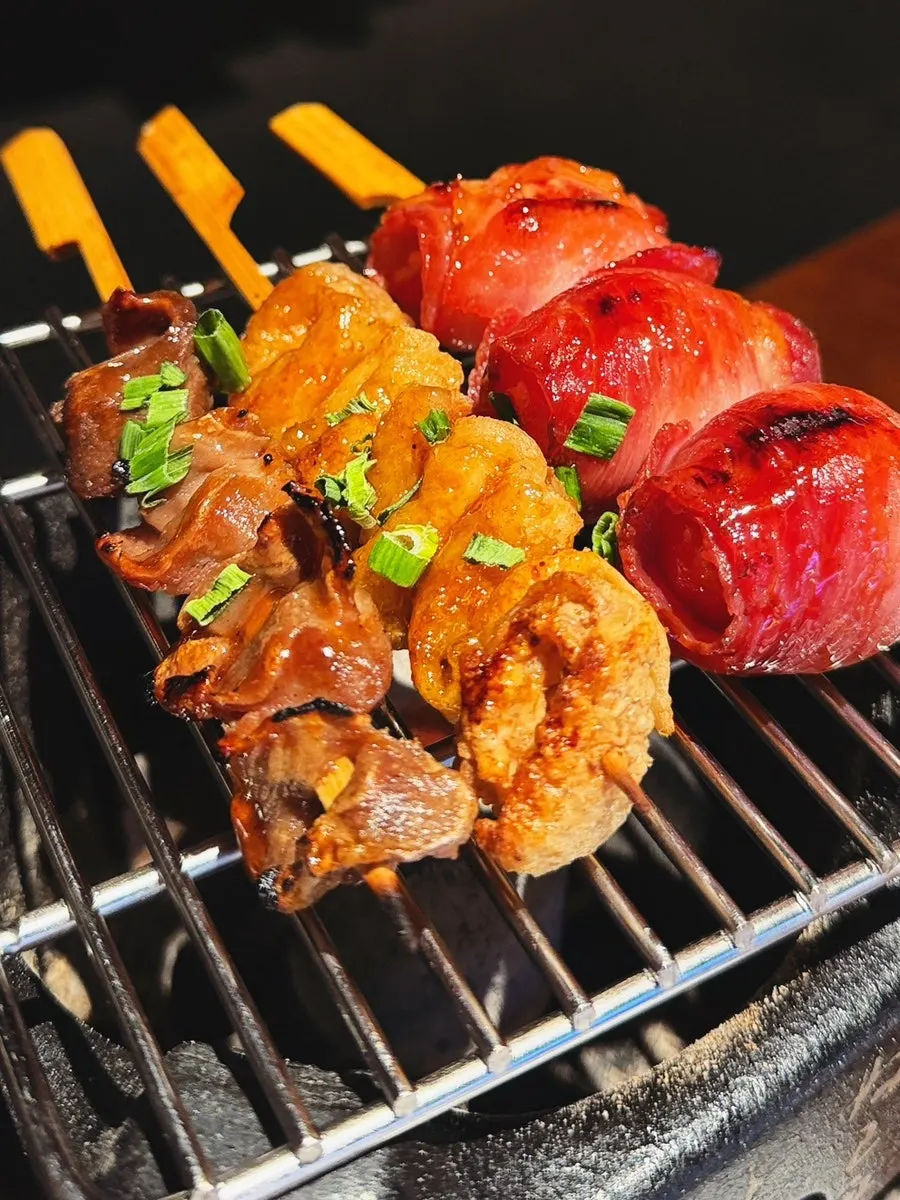 Skewers warming over the personal grill