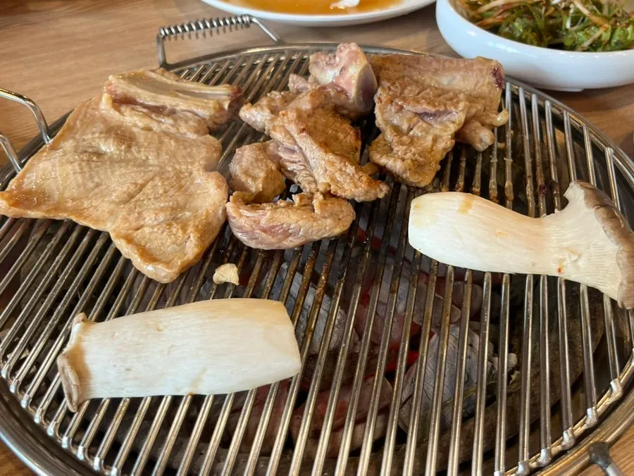 Seasoned ribs cooking over the charcoal fire