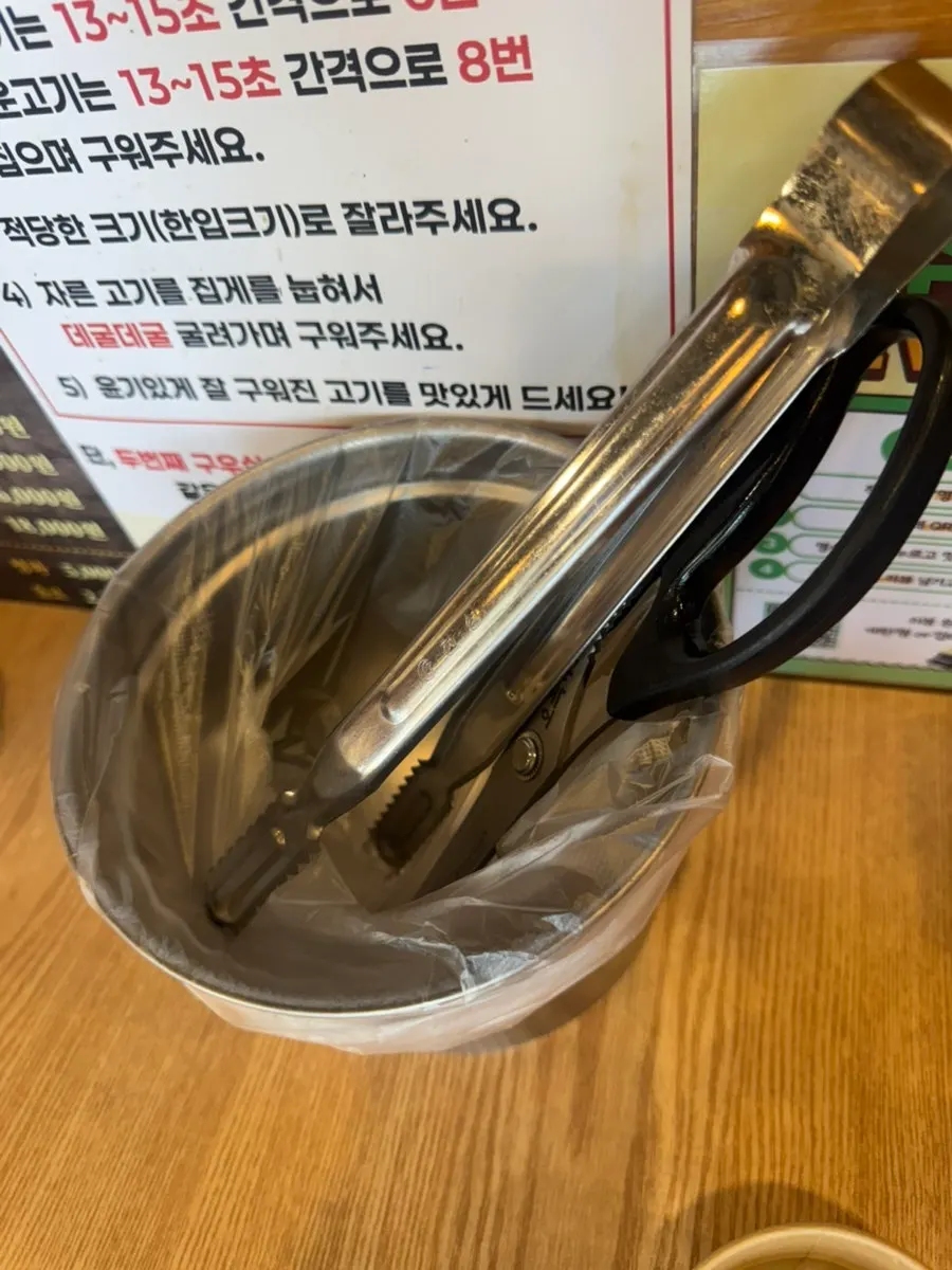 Table setting with water, tongs, and scissors
