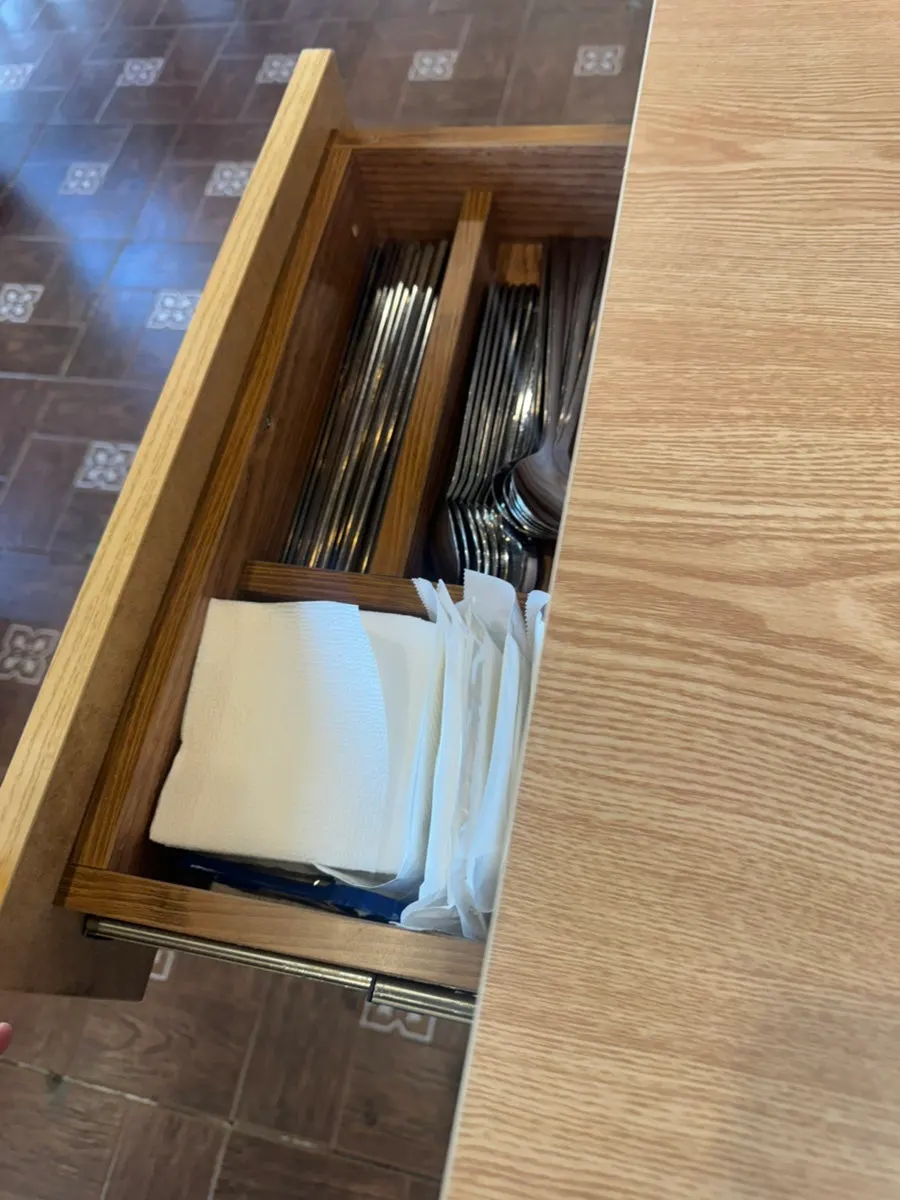 Table stocked with paper cups, spoons, and napkins