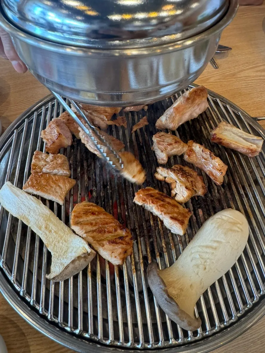 Marinated pork galbi cooking over charcoal