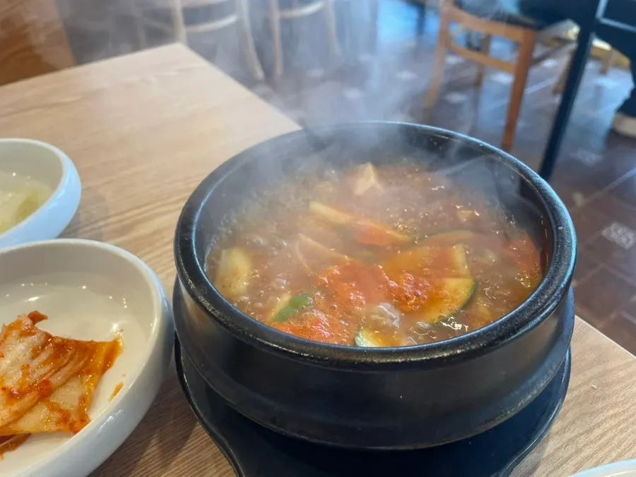 Doenjang jjigae served in a stone pot alongside rice