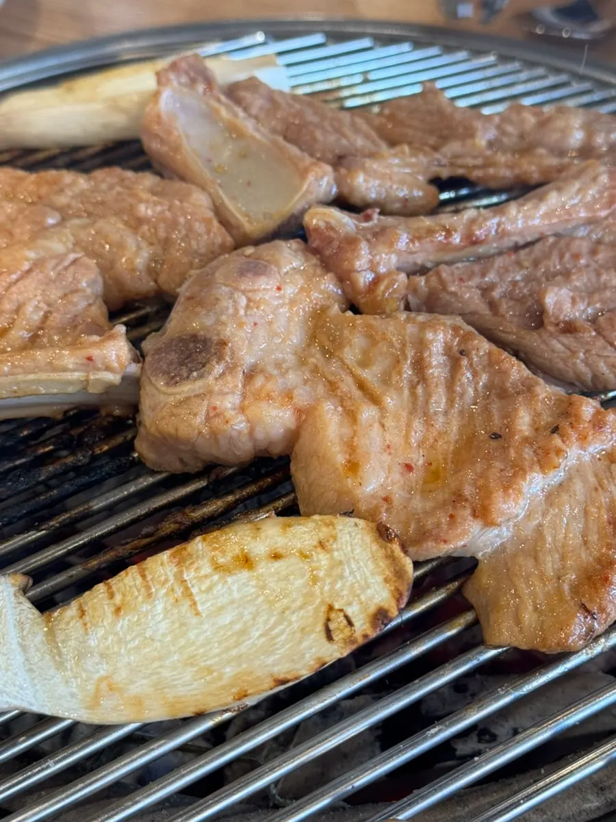 Seasoned galbi flipped often while grilling