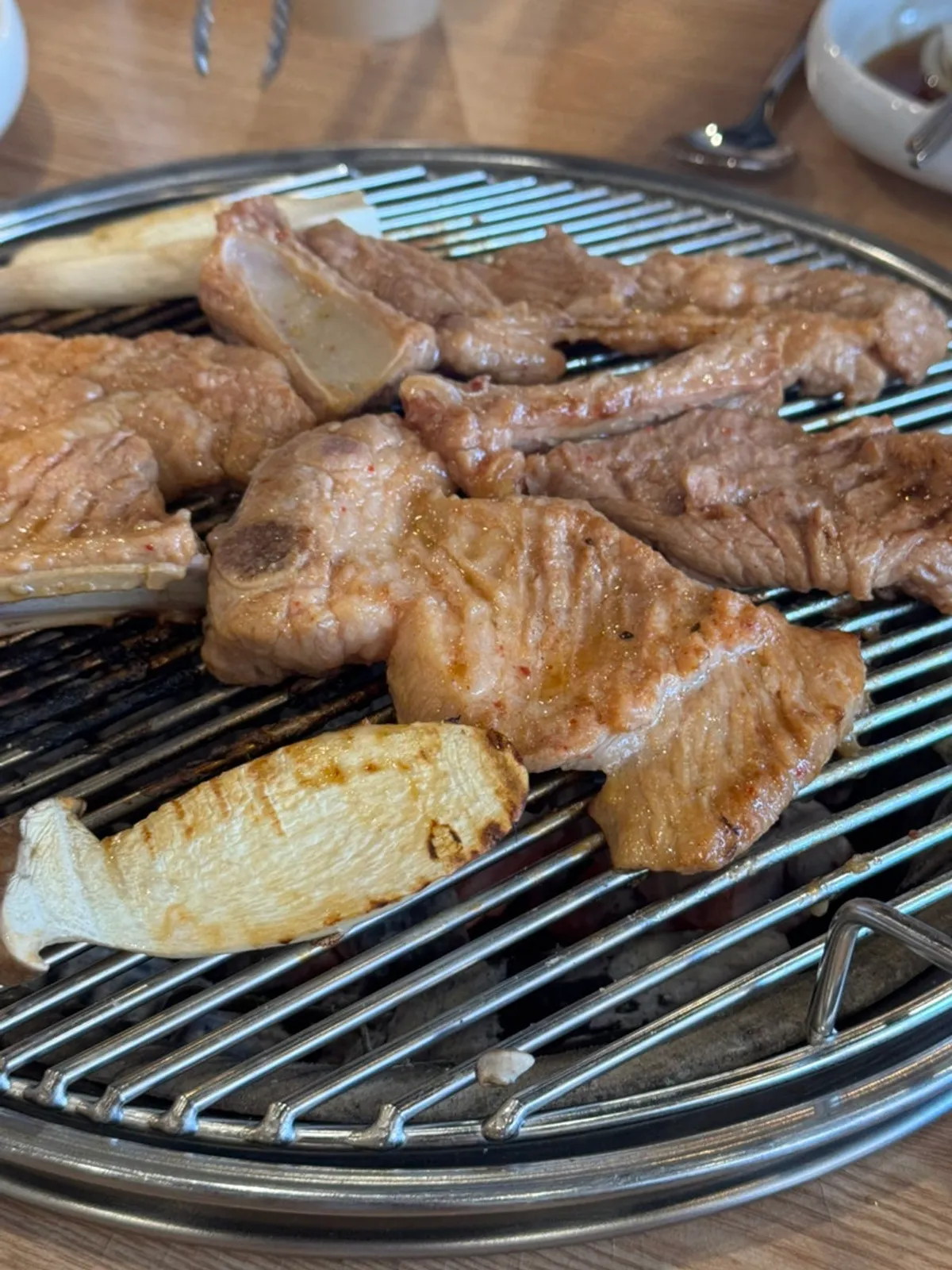 Close-up of charcoal-grilled seasoned pork galbi with a smoky finish