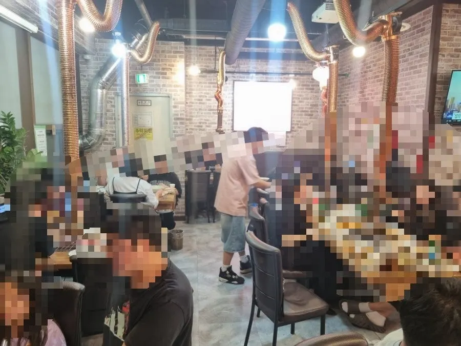 Restaurant interior packed with customers