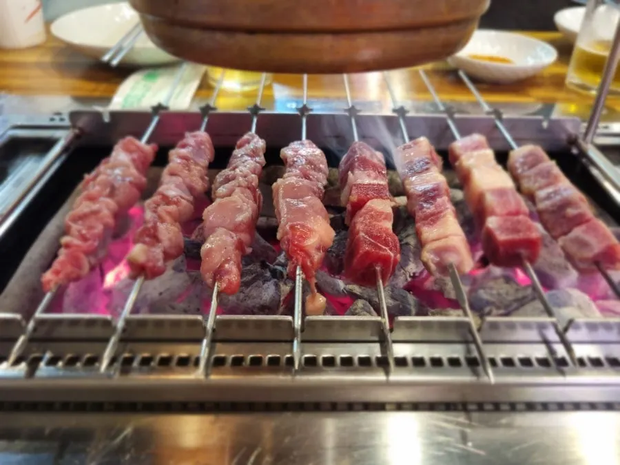 Bright red yang kkochi and lamb rib meat skewers before grilling
