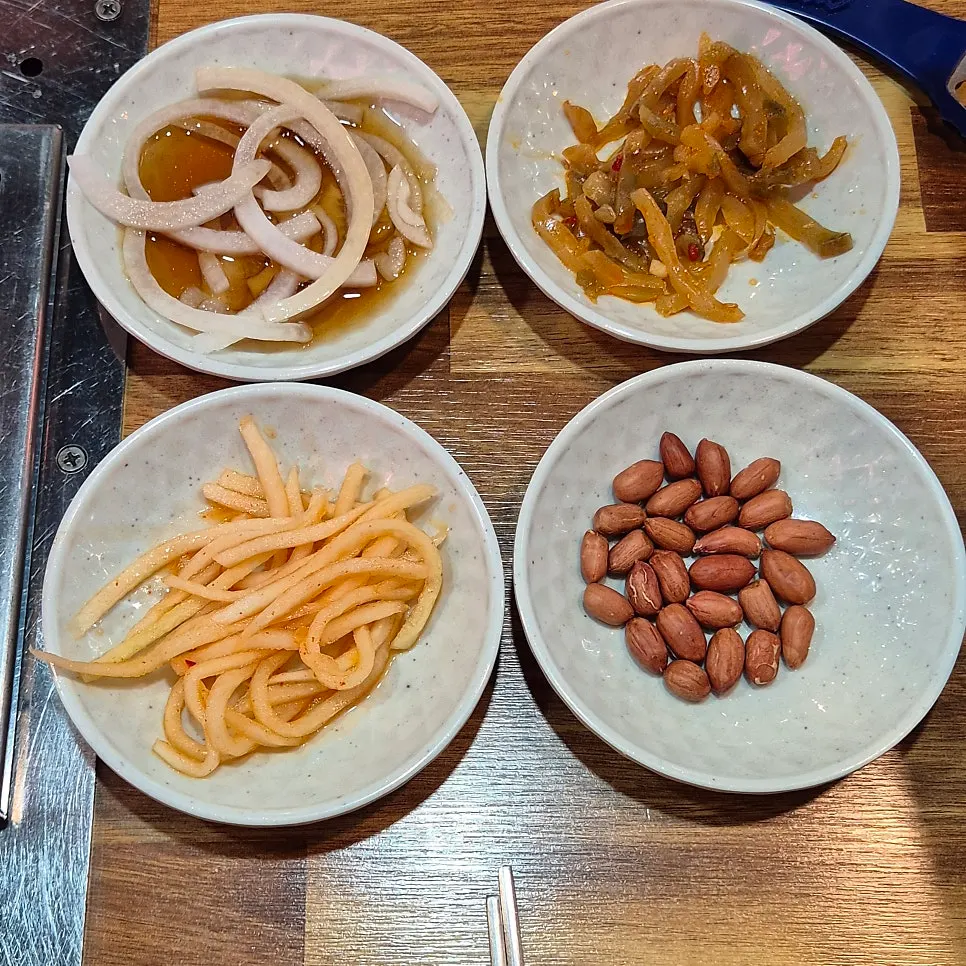 Basic banchan: pickled onion, radish salad, peanuts, zha cai