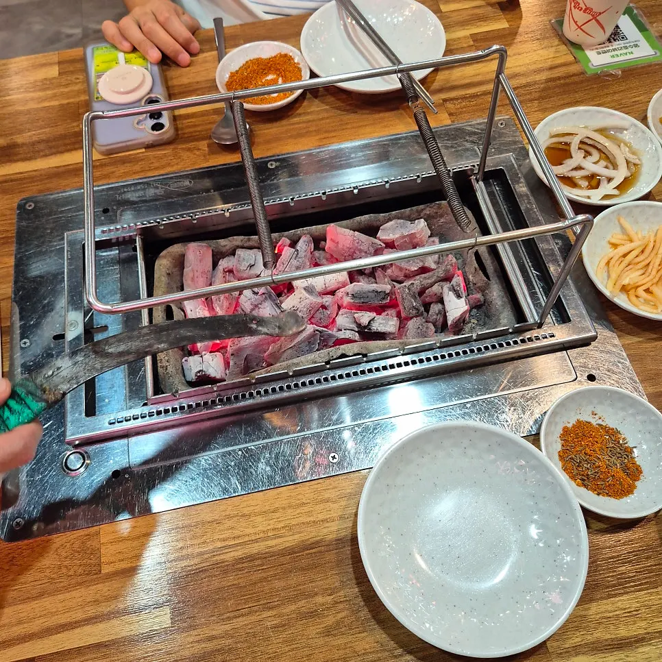 Table setting with two servings of ordered lamb skewers