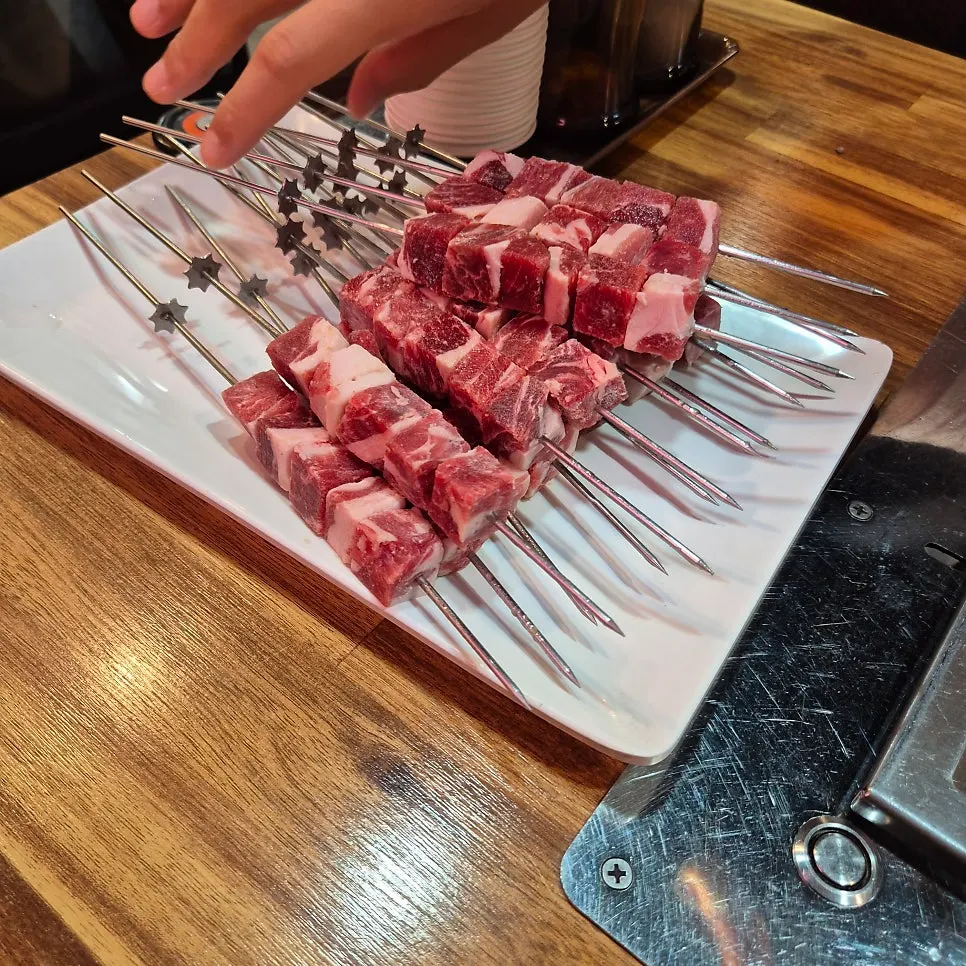 Thick lamb skewers on the charcoal grill
