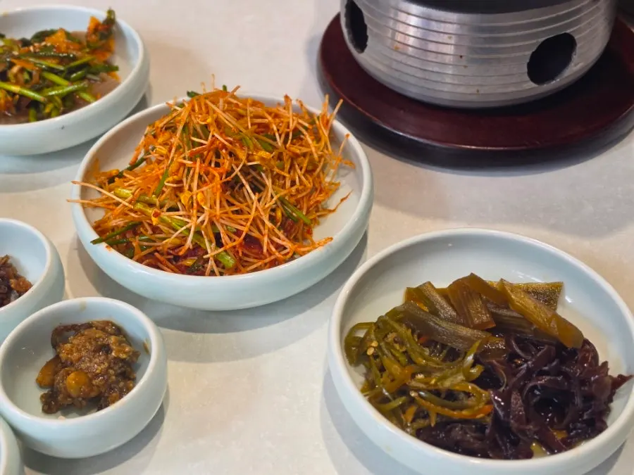 Plate of vegetables and sauces among Sanseong Meat Shop's basic side dishes