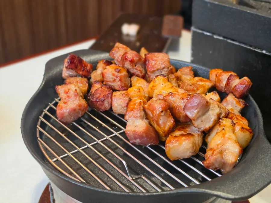 Thick yeast-aged pork neck grilling on the plate