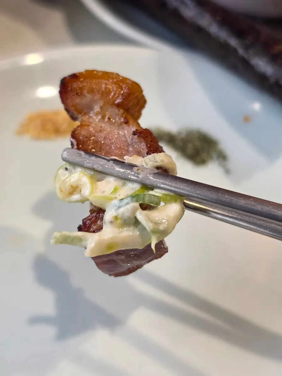 Grilled yeast-aged pork neck sliced into bite-sized pieces
