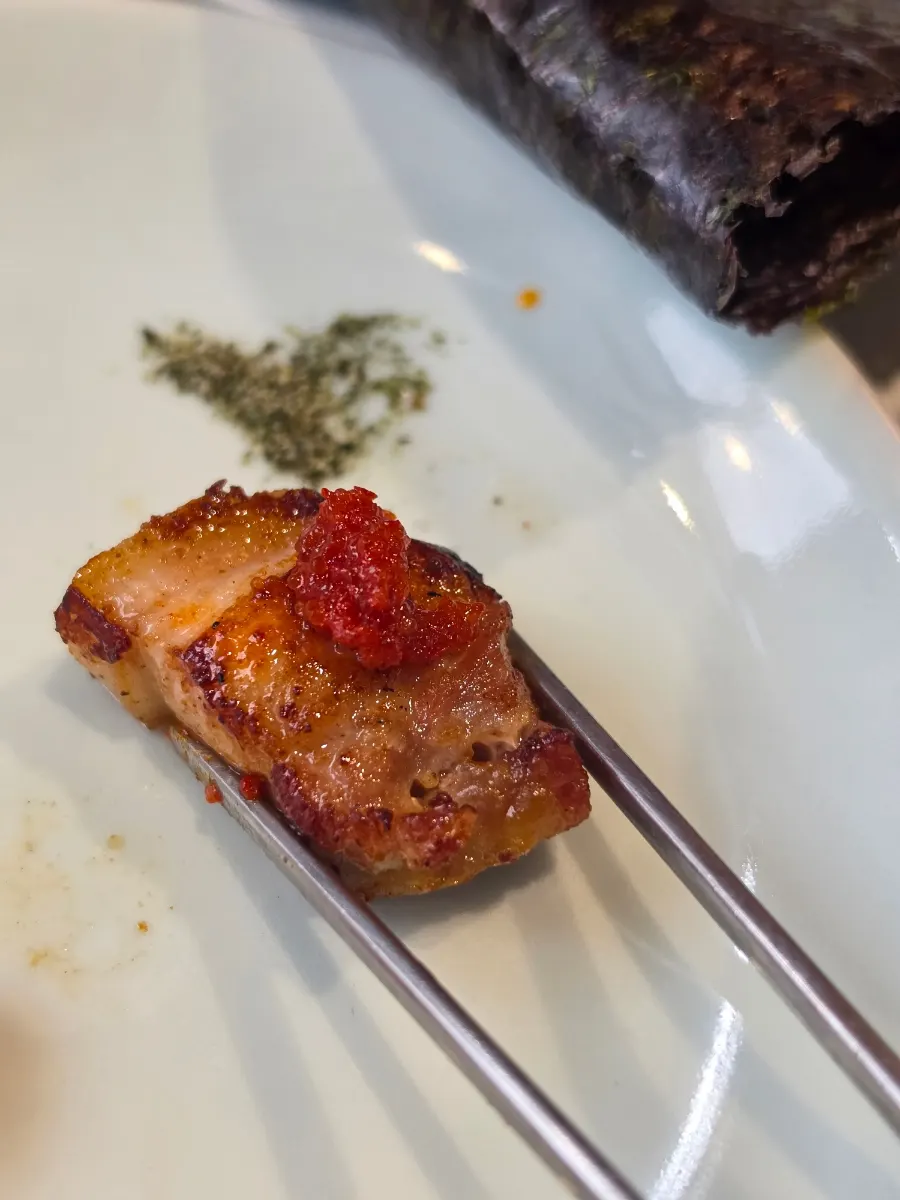 Piece of pork belly topped with truffle scallion mayo