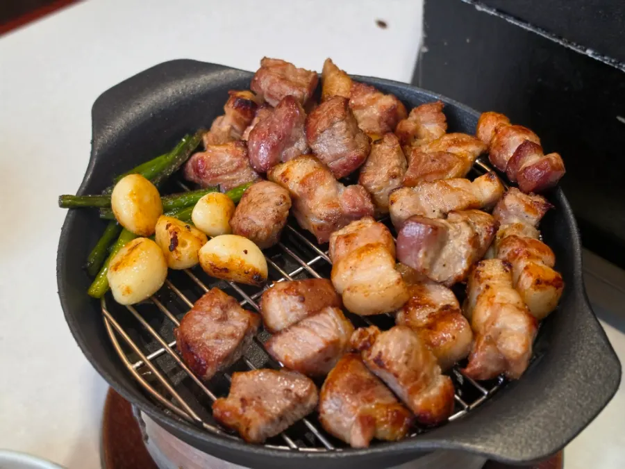 Pork belly kept warm on the small charcoal brazier