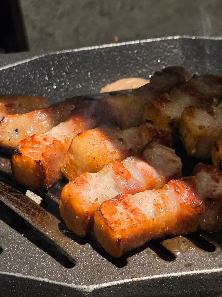 A piece of meat topped with grilled garlic