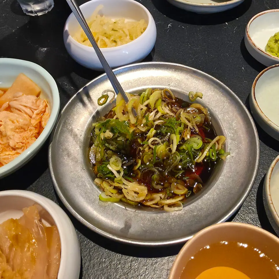 Side dish spread with mukeunji and scallion soy paste