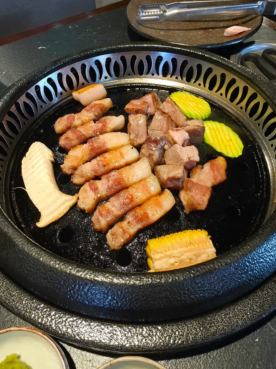 Vertical photo of staff grilling the meat