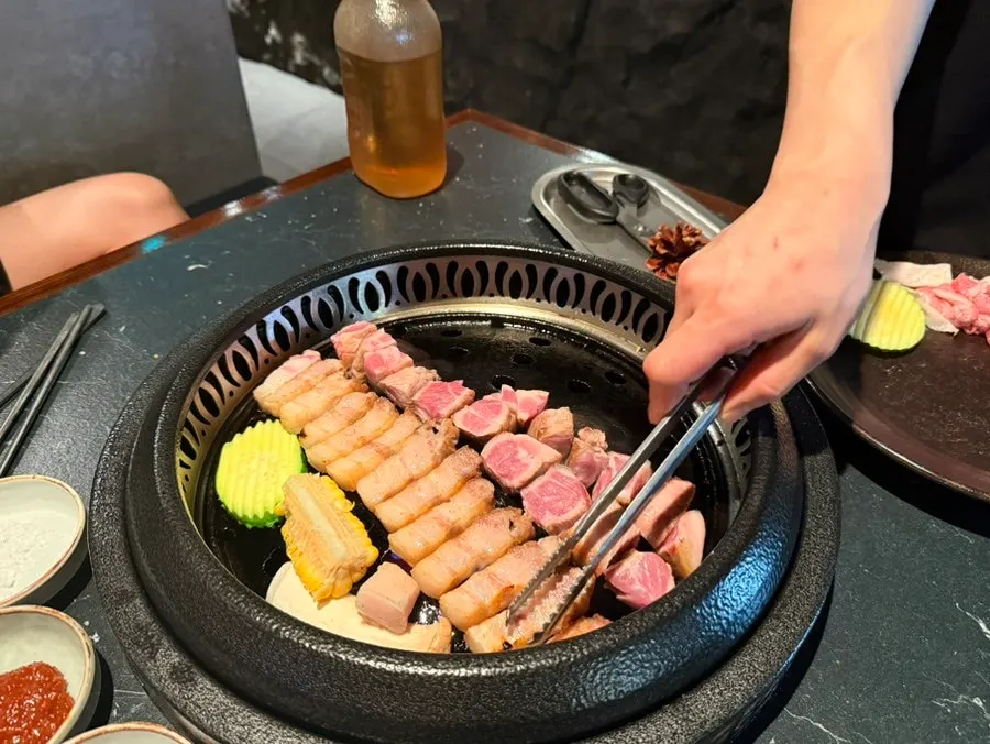 Staff member grilling the meat