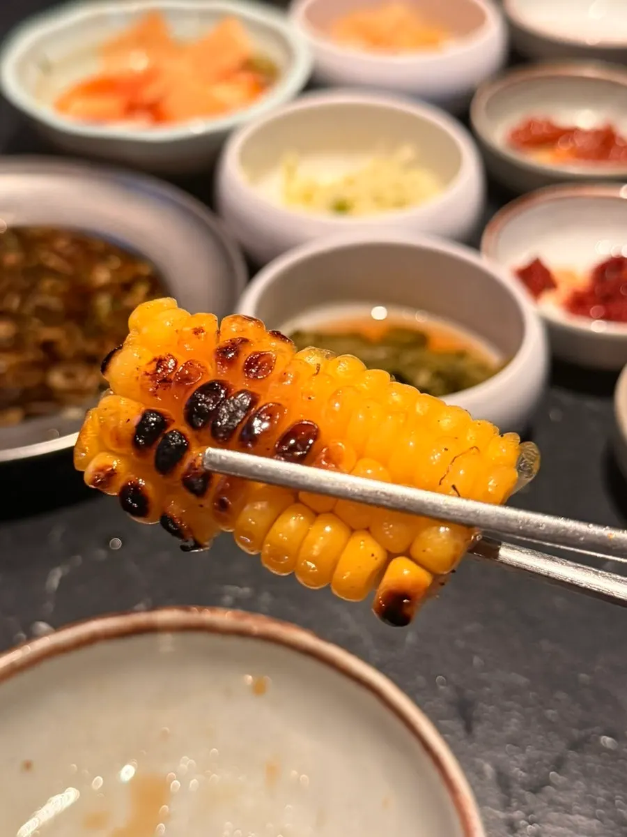 Garnish vegetables cooking at the edge of the grill